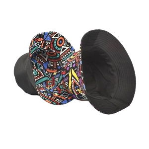 Reversible bucket hat with solid black and colorful geometric tribal pattern design