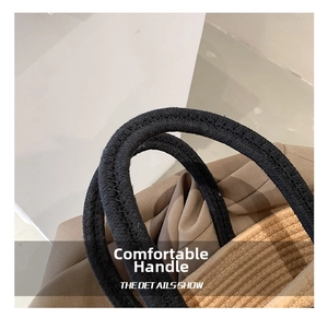 Detail of hand-woven cotton rope handle with dense texture on contrast tote bag
