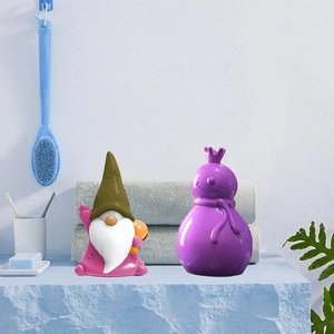 Christmas gnome and snowman silicone molds for DIY candle making on a blue vanity