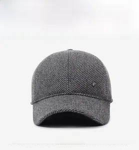 Detailed front view of dark grey winter baseball cap showing thick tweed fabric texture