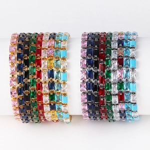 Detail of colorful rectangular zircon bracelets in gold and silver metal finishes