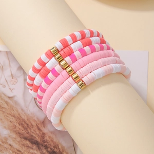 Detail of five-piece Bohemian colorful heishi clay bead bracelets with gold metal accents