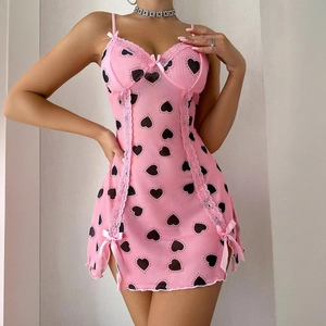 Close-up of pink mini dress featuring black heart prints and delicate lace trim details