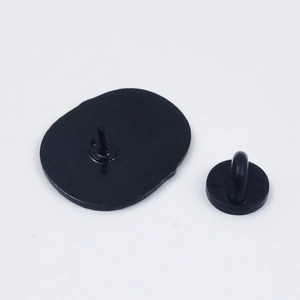 Close-up of the black rubber clutch and secure metal pin backing for cat brooch