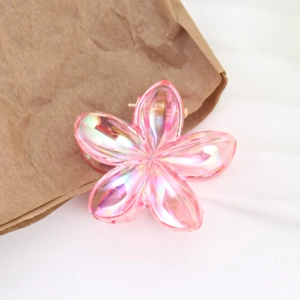 Pink iridescent resin frangipani flower hair claw clip for beach vacations