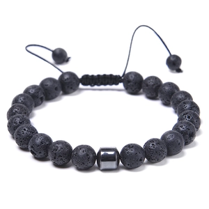 Close-up of volcanic lava stone beads and hexagonal metal hematite on adjustable cord