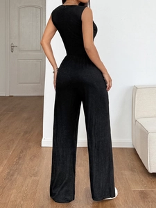 Back view of a sleeveless wide-leg black jumpsuit showing the cinched waist design