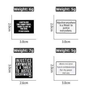 Detail showing four black and white geometric enamel quote pins with sizes and weights