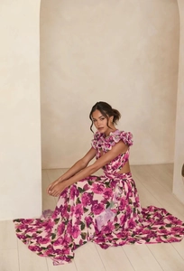 Detail of pink floral maxi dress with side cut-outs and ruffled V-neckline ruffles