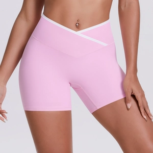 Detail of high-waisted yoga shorts with V-cross waist and white contrast piping trim