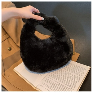 Close-up of black fuzzy faux fur tote bag showing plush texture and round handle