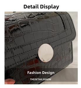 Close-up of black crocodile pattern leather texture with round silver metal buckle
