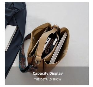 Detail view of large capacity tote bag with internal compartments and ethnic shoulder strap