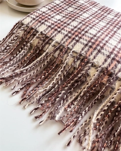 Close-up of retro brown plaid cashmere scarf texture with dense fringe details