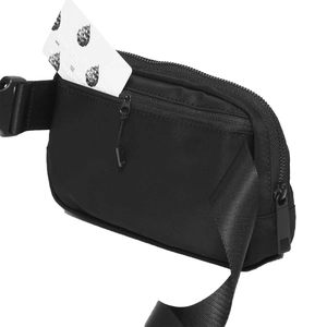 Detail of black nylon sports waist bag with adjustable strap and durable buckle
