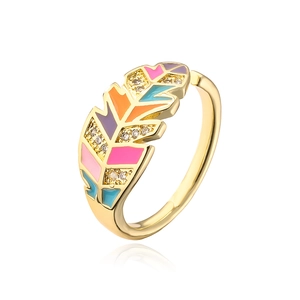 Close-up of golden leaf ring with colorful enamel inlay and sparkling zircon stones