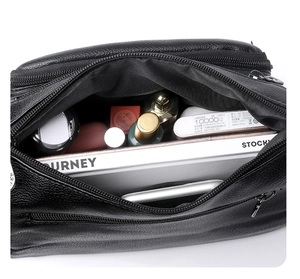 Detailed interior view of black soft leather handbag, showing spacious storage for daily items.