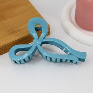 Detail of 13cm blue ribbon bow hair claw clip with glossy finish and dense inner teeth