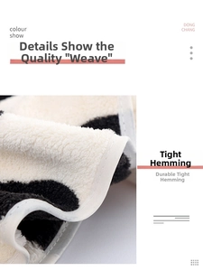 Close-up of coral fleece towel showing tight overlock edging and cow print texture