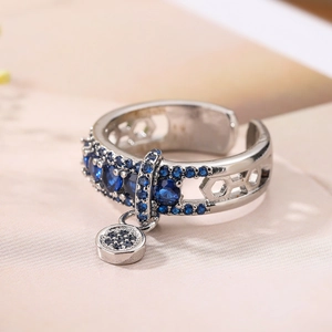 Macro view of adjustable silver ring with blue zircon stones and honeycomb hollow details