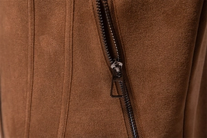 Close-up of premium brown suede fabric texture and durable metal zipper on male jacket