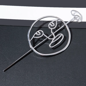 Detailed close-up of a silver minimalist abstract face hair stick with a polished mirror finish
