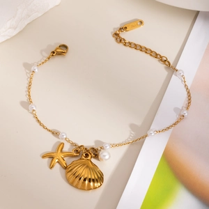 Golden stainless steel charm bracelet with sea shell, starfish charms and white pearls