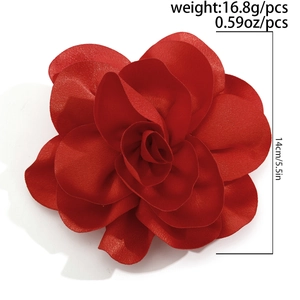 Detailed macro view of a large 14cm red fabric flower brooch with layered satin petals