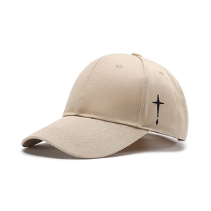 Classic beige cotton baseball cap featuring black cross embroidery and curved brim