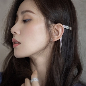 Detail of silver tassel hair clip and heart stud earrings set with sparkling rhinestones