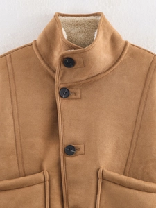 Detailed view of camel faux suede jacket featuring black buttons and soft lamb wool lining