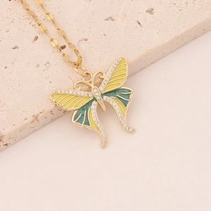 Elegant gold butterfly necklace with yellow green enamel and sparkling crystals