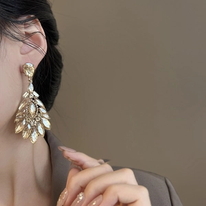 Vintage gold drop earrings with champagne crystals in a luxury feather-like design
