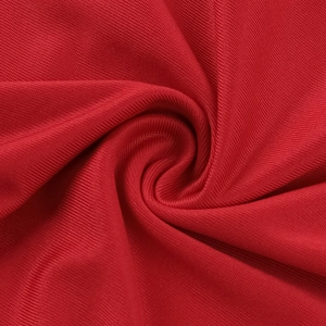 Macro shot of red knitted fabric texture and elegant pleats on a slim fit dress