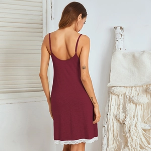 Close-up of elegant burgundy sleepwear with delicate white floral lace trim on the hem