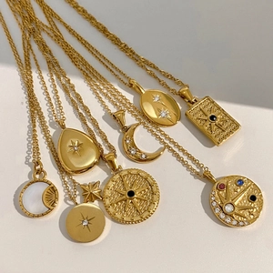 Gold stainless steel celestial necklaces featuring sun, moon, and star pendants with zircons