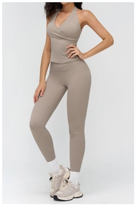 Detail of taupe brushed yoga set featuring cross-back halter top and high-waisted leggings