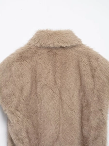 Detail of light brown faux fur vest neck area and soft plush fiber texture