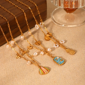 Detail of gold layered necklaces with sea shells, starfish pendants and pearls