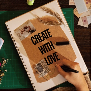 Detail of vintage DIY scrapbook with vinyl letter stickers and dried flower decor