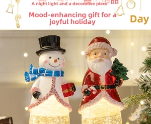 Close-up of festive Santa and Snowman night lights with warm glowing bokeh background