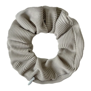 Detail view of light grey ribbed fabric scrunchie with a functional hidden zipper pocket