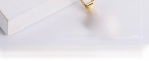 Macro shot of gold plated titanium steel heart pendant with LOVE cutout design