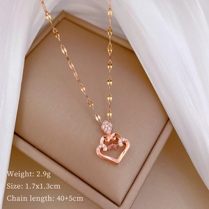 Macro detail of rose gold heart pendant with sparkling cubic zirconia on soft silk