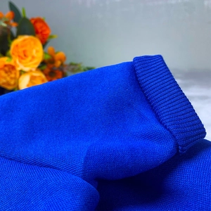 Detail shot of the blue knitted pet sweater showing premium ribbed texture and fabric