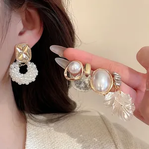 Elegant asymmetrical gold earrings with pearls and crystal flower petals for women