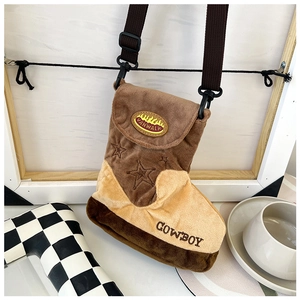 Detail of western cowboy boot shaped plush crossbody bag with star embroidery