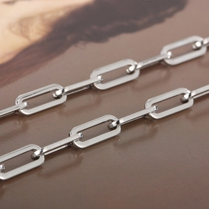 Close-up of a silver stainless steel rectangular link chain with a polished metallic finish