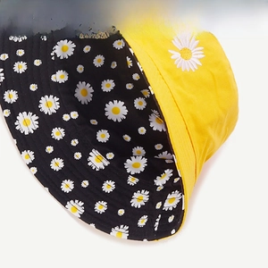 Detailed view showing yellow canvas bucket hat with daisy embroidery and floral lining