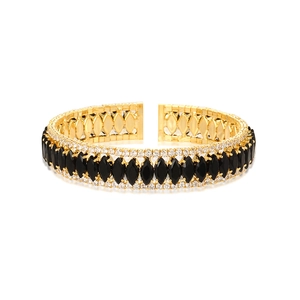 Detailed macro view of gold-plated bracelet with black marquise zircons and pavé diamonds